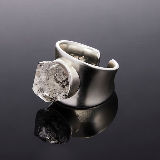 Sculptural silver Goblin ring with raw Mexican Quartz on black background by QiBai London