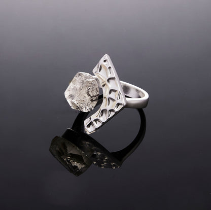 Silver Echo Gate crystal ring on a reflective black background by QiBai London